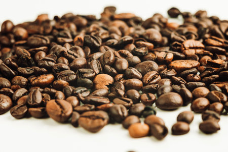 roasted coffee beans are in pile isolated on white,can be used as background or texture. Roasted...