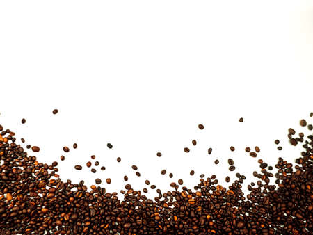 coffee beans scattered on a white background. aromatic arabica on a background with copy space. mockupの写真素材