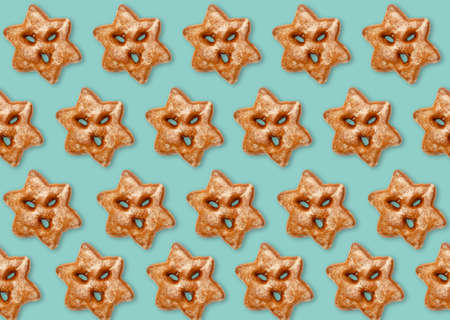 Blue Christmas background. Seamless gingerbread pattern. Winter holidays ornament. White gingerbread cookies minimalistic symmetric composition isolated on bright. Mockup for design.の写真素材