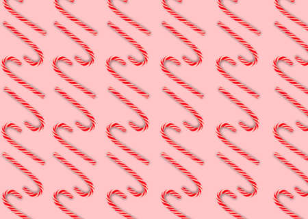 Flat composition with lollipops on a pink background. Candy cane striped pattern in Christmas colors. Red and white striped lollipop. Christmas background. Candy shop concept.の写真素材