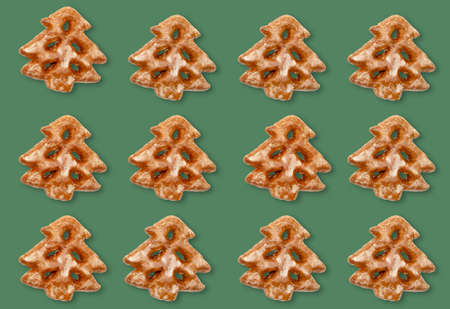 Christmas tree pattern. Green seamless background. Winter holidays ornament. Beige white gingerbread festive minimalistic symmetrical composition isolated on green mockup for design.の写真素材