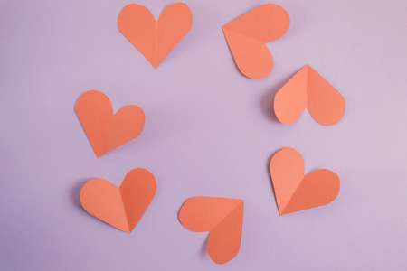 Valentines day background. Red hearts laid out in a circle on a pastel purple background. Valentines day concept. Layout for postcards and congratulations. Flat lay, top view, copy spaceの写真素材