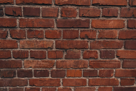 The texture of an old brick wall with natural defects. Scratches, cracks, crevices, chips, dust,...