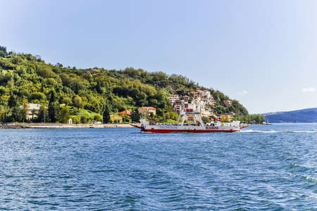 Kamenari, Montenegro - July 25, 2021: Beautiful view of the Bay of Kotor and regular passenger ferry. Ferrying people and cars across the bay on a sunny summer dayのeditorial素材