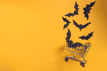 Festive halloween background with paper bats on a shopping trolley.Mock up flatly for party or sale. Top view.Copy Spaceの写真素材
