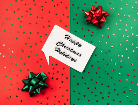 Happy christmas holidays text.Green and red background with sparkles and bows for gifts. holiday...