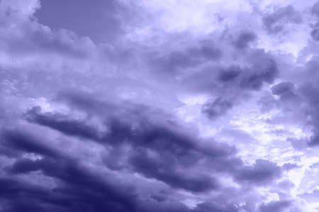 the sky covered with thunderclouds in summer. Trending toning Very Peri color.の写真素材