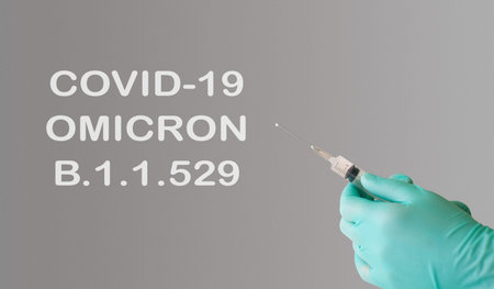 A doctor holds a vaccine against a new variant of omicron covid-19. Vaccine against the South...
