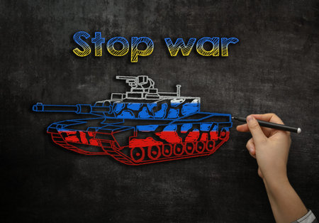 a Russian tank is drawn on the school board with the text stop warの写真素材