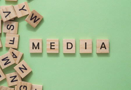 Text media on wooden cubes on green background. High quality photo