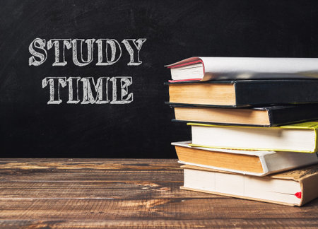 A stack of books with the word study time written on top. The books are piled on top of each other,...