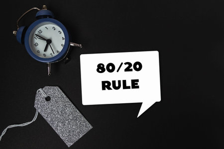 A blue clock sits on a black background with a tag that says 80/20 rule. The clock is set to the...