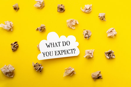 A yellow background with a white sign that says What do you expect. The sign is surrounded by...