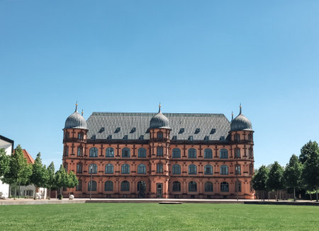 A large building with a gray roof. The building is surrounded by trees and has a large courtyardの写真素材