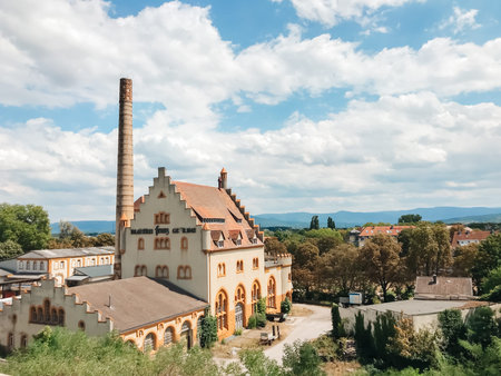 A large building with a tower. The building is surrounded by trees and has a peaceful atmosphere