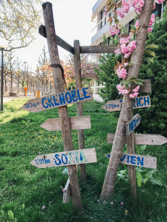 A sign with a blue arrow pointing to the right, indicating directions to various locations. Ideal for travel guides and navigation-themed content.の写真素材