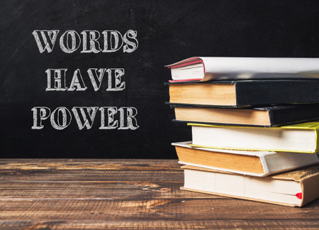 A stack of books with the words words have power written on top. The image conveys the idea that words have the ability to influence and impact people's livesの写真素材