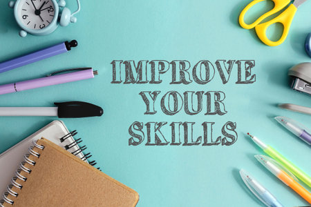 A desk with various office supplies, including pens, scissors, and a clock. The words improve your skills are written in a cursive font above the suppliesの写真素材