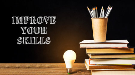 A stack of books with a light bulb on top of them and the words improve your skills written below