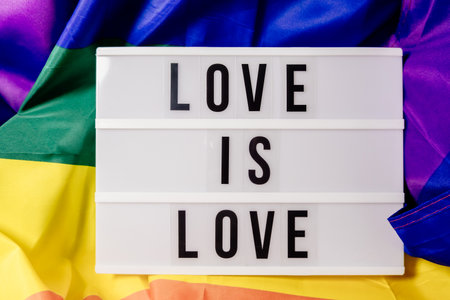 A white sign with the words love is written on itの写真素材