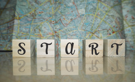 A wooden block with the word start written on it. The blocks are arranged in a row, with each block...