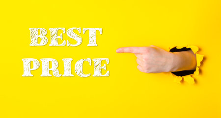 Hand pointing to the word best price on a yellow background. Concept of urgency or importanceの写真素材