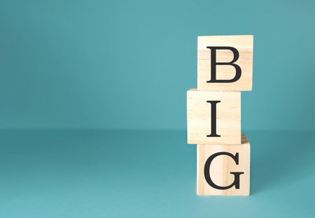The blocks are arranged in a way that they spell out the word BIG in a creative and artistic mannerの写真素材
