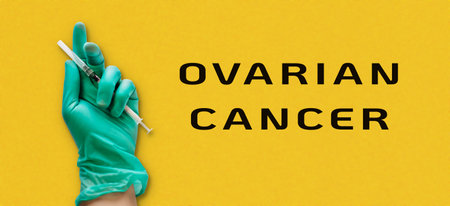 Person holding a syringe with the words Ovarian Cancer written below. The image has a medical and serious toneの写真素材