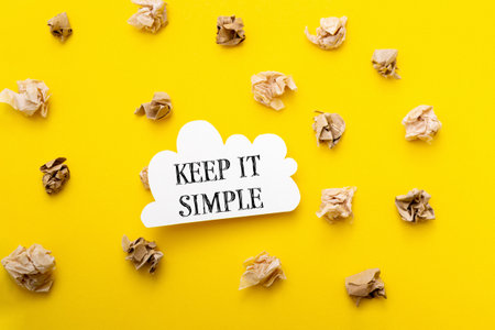 Keep it simple is written in bold black text on a bright yellow background, creating a minimalistic and clear visual with a focus on simplicity and clarity.の写真素材