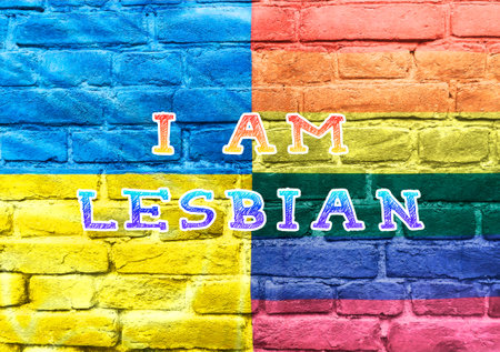 Colorful brick wall with the words I am written on it. The colors of the wall are yellow, blue, green, and redの写真素材