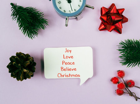 A white paper with the words joy, love, peace, believe, Christmas written on it