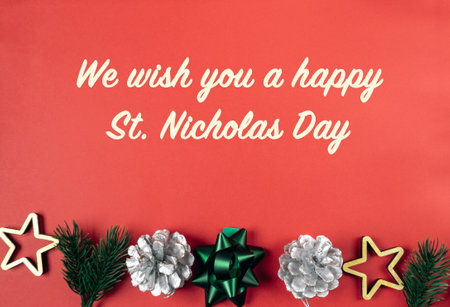 A red background with a Christmas tree and stars. The message is We wish you a happy St. Nicholas Dayの写真素材