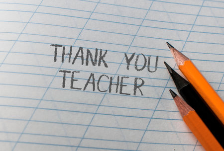 A pencil drawing of a thank you note to a teacher. The pencils are placed on top of the paper, with the words thank you teacher written in the middle. The drawing conveys a sense of gratitudeの写真素材