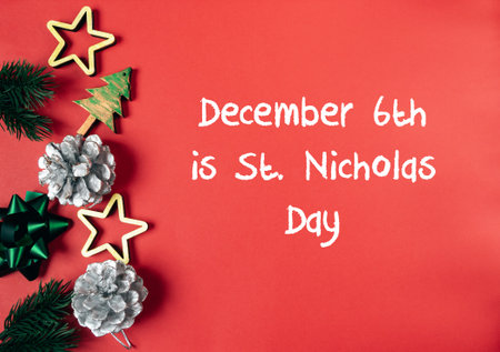 Red background with a Christmas tree and pine cones. The text reads December 6th is St. Nicholas Dayの写真素材
