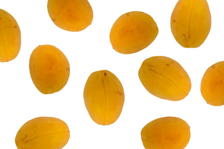 Bunch of yellow fruit with a white background. The fruit is ripe and ready to eat. Concept of abundance and freshnessの写真素材