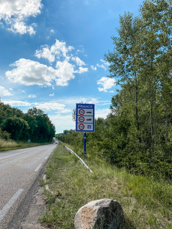 Sign on a road that says "France" and has a no car sign on it.の写真素材