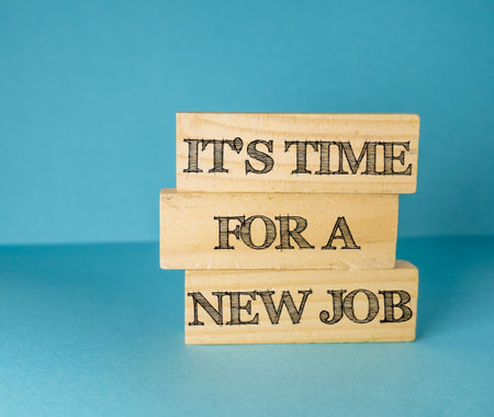Wooden block with the words "Its time for a new job" written on itの写真素材