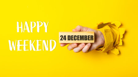Person holding a block of wood with the words Happy Weekend on it. The block of wood is in front of...