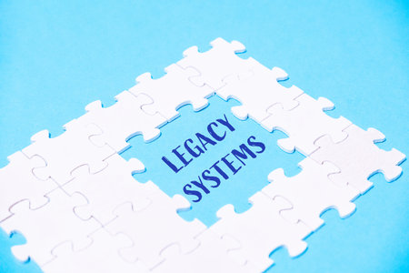 White puzzle piece with the word Legacy Systems written in blueの写真素材