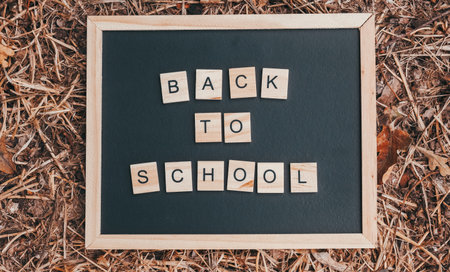 Blackboard with the word back to school written on itの写真素材