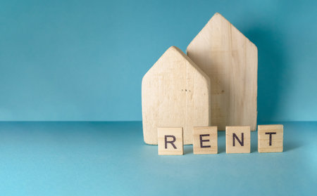 Wooden house with the word rent written on itの写真素材
