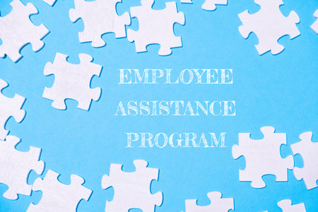 Jigsaw puzzle with the words employee assistance program written on itの写真素材