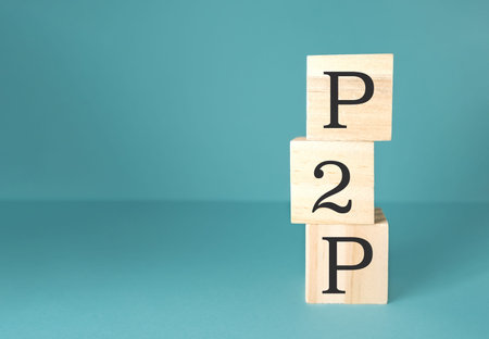 Stacked wooden blocks featuring the letters P, 2, and P are positioned against a smooth blue...