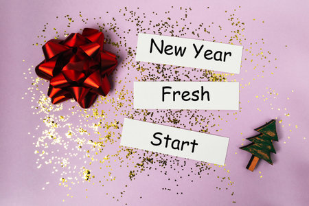 New Year celebration scene featuring vibrant decorations, glitter, and motivational phrases on a pastel background, creating a joyful and inspiring atmosphere for fresh beginningsの写真素材