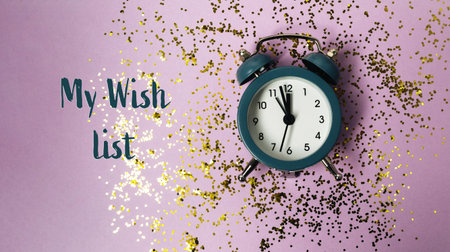 Alarm clock placed on a purple surface surrounded by glitter, symbolizing a festive wish list for...