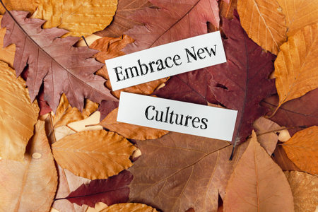 Vibrant autumn leaves in rich colors of orange, red, and brown frame two white paper strips with the...