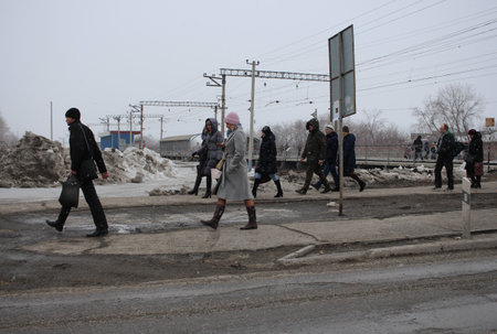 Russia, Novosibirsk 03/27/2020: people passengers walking down the street arrived by train from the stationのeditorial素材