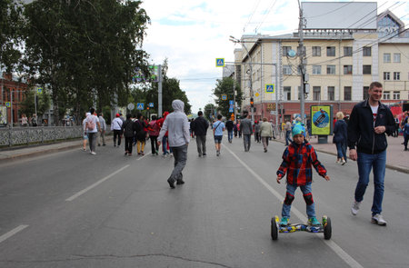 Russia, Novosibirsk, 30.06.2019: people cheerful tourists walking down the street with children in the city relaxのeditorial素材