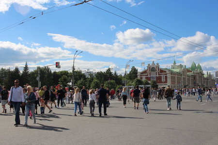 Russia, Novosibirsk 06/30/2019: happy people tourists walking in the city on the street resting on the holiday men and women with childrenのeditorial素材