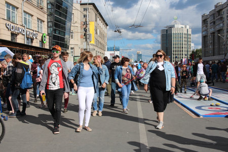 Russia, Novosibirsk 06/30/2019: happy people tourists walking in the city on the street resting on the holiday men and women with childrenのeditorial素材